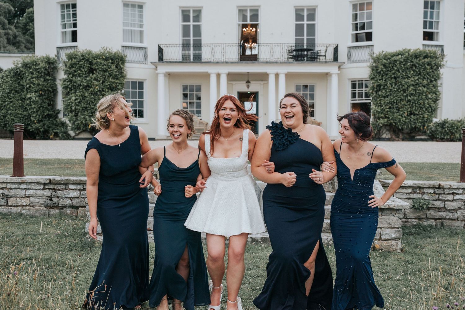Group portraits with bridesmaids in front of Rockbeare Manor entrance