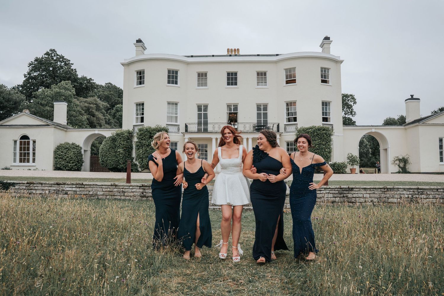 Group portraits with bridesmaids in front of Rockbeare Manor entrance