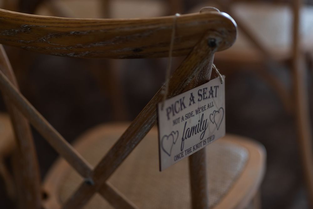 Rustic wooden directional signs at a wedding venue.