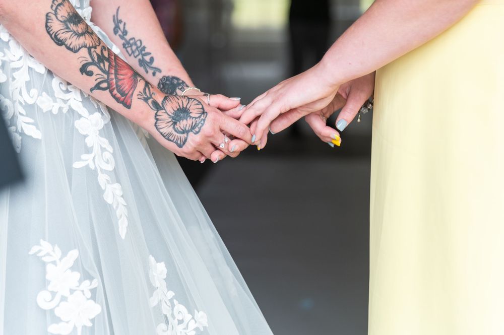 Wedding party members wearing elegant gray and yellow dresses standing together.