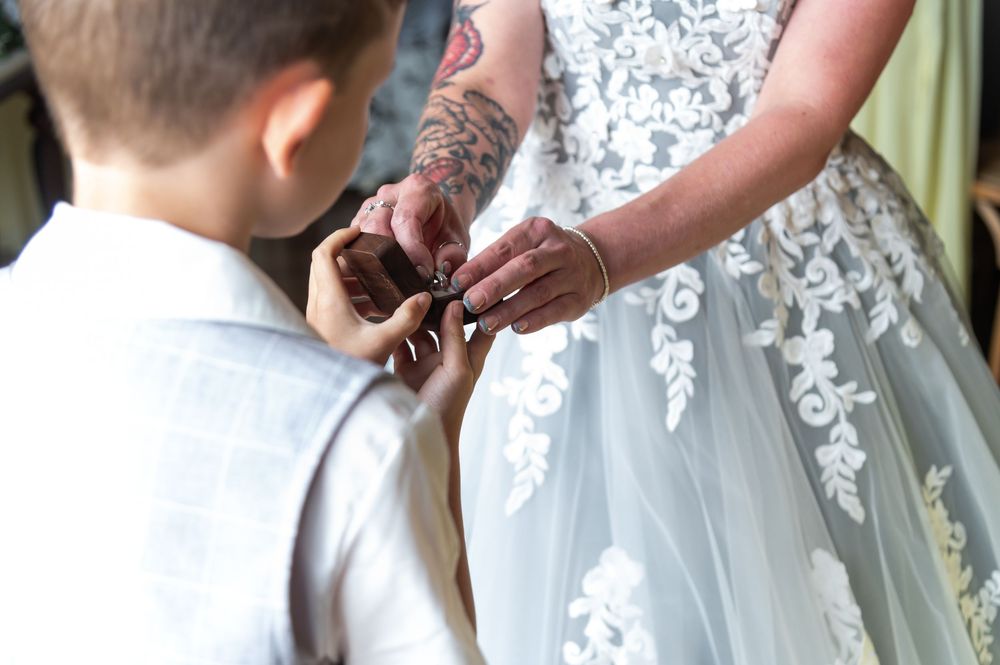 Close-up of intricate lace details on wedding dress bodice.