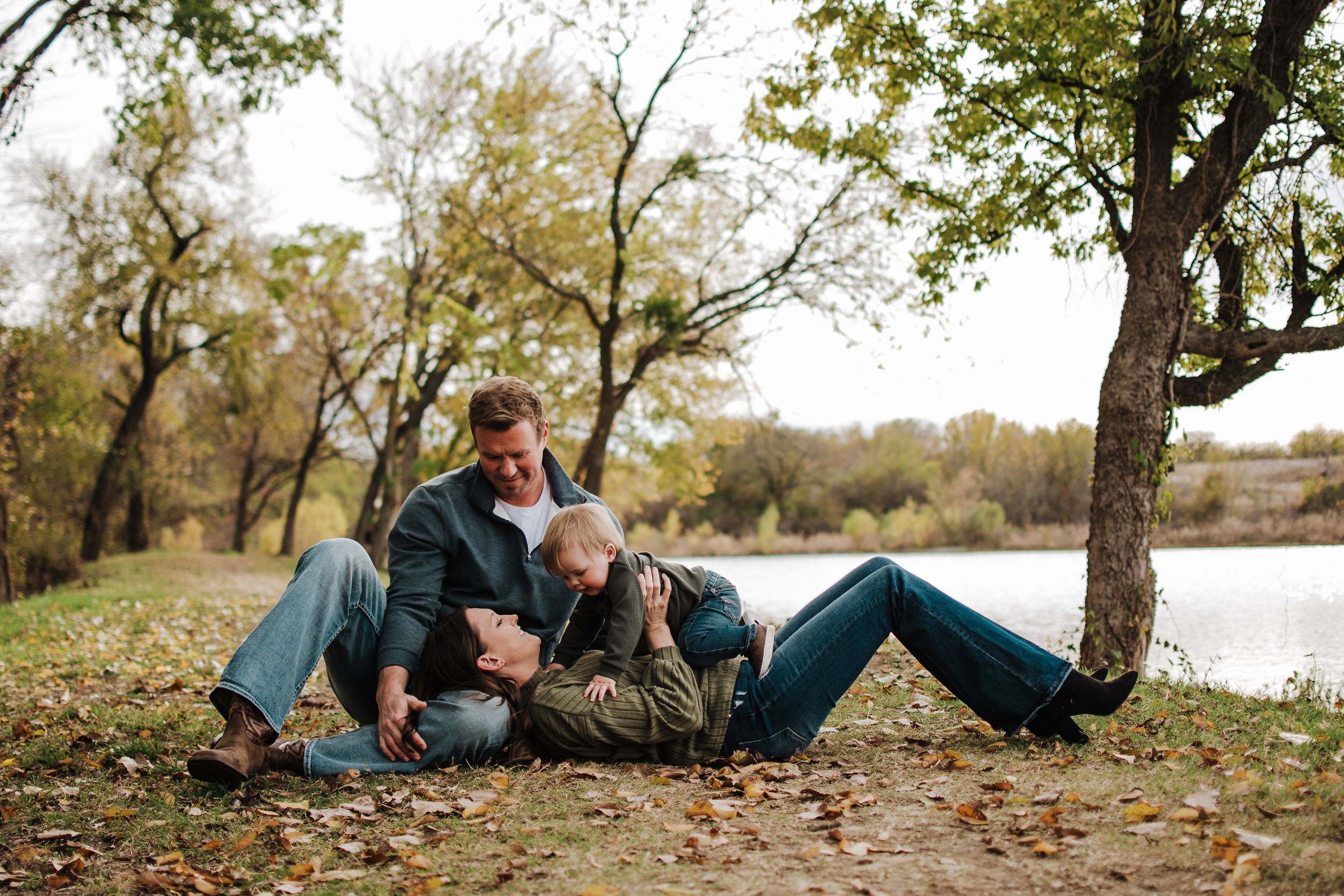 Family playing in fall leaves during Fort Worth mini session at Northwest Community Park