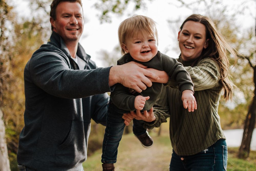 Family playing in fall leaves during Fort Worth mini session at Northwest Community Park