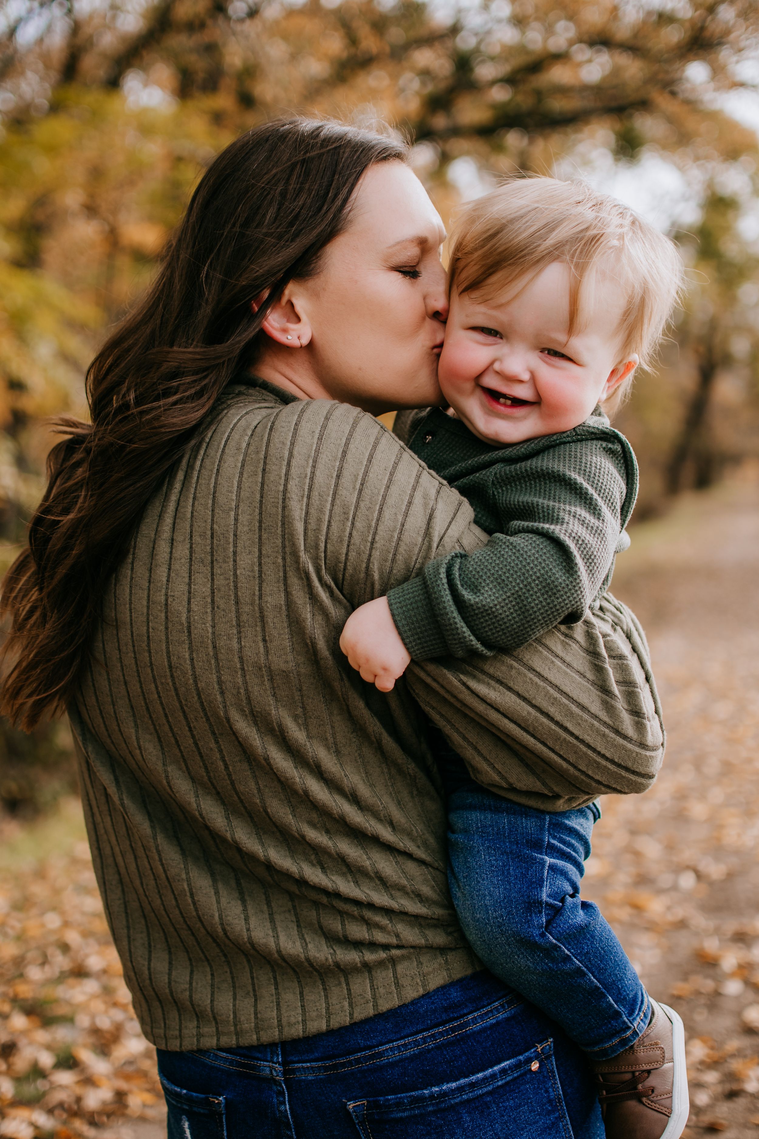Family playing in fall leaves during Fort Worth mini session at Northwest Community Park