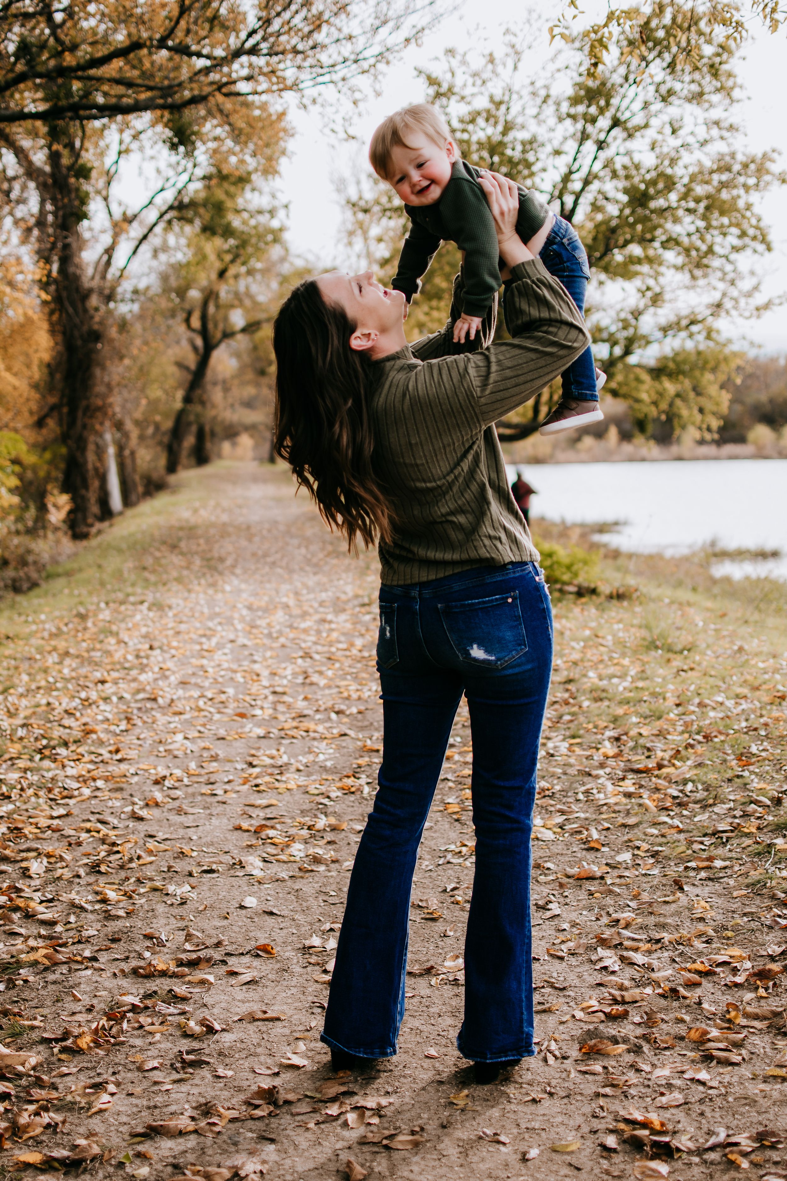 Family playing in fall leaves during Fort Worth mini session at Northwest Community Park