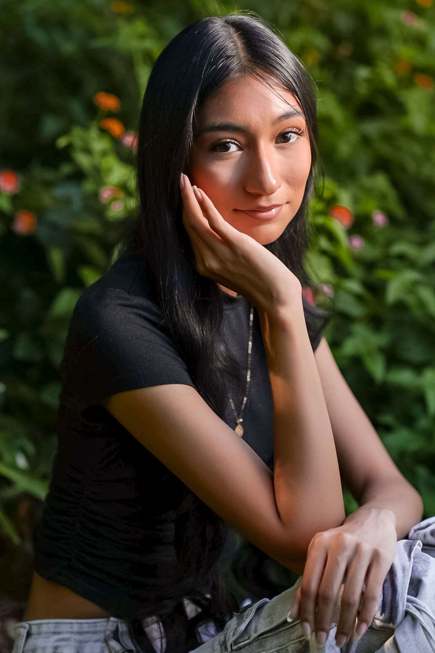 A series of candid outdoor portraits showing someone in a black top against a green garden background with orange flowers.