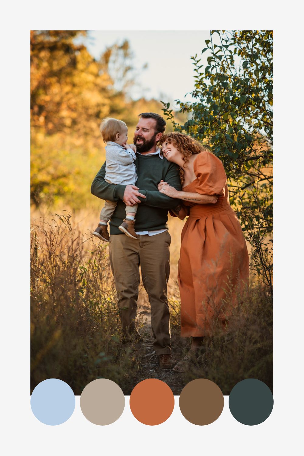 A family of 3 poses together on an autumn path with fallen leaves, showcasing a warm earthy color palette in their outfits.