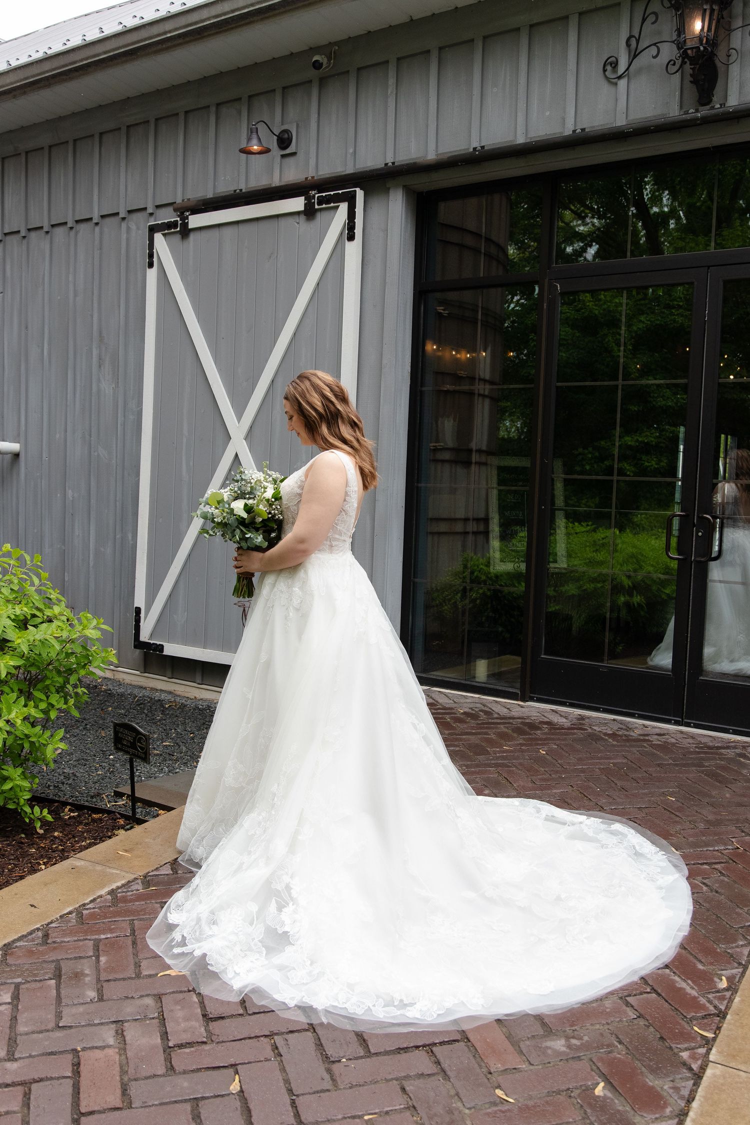 A bride taking a quiet moment outside her venue in Burlington, Wisconsin.
