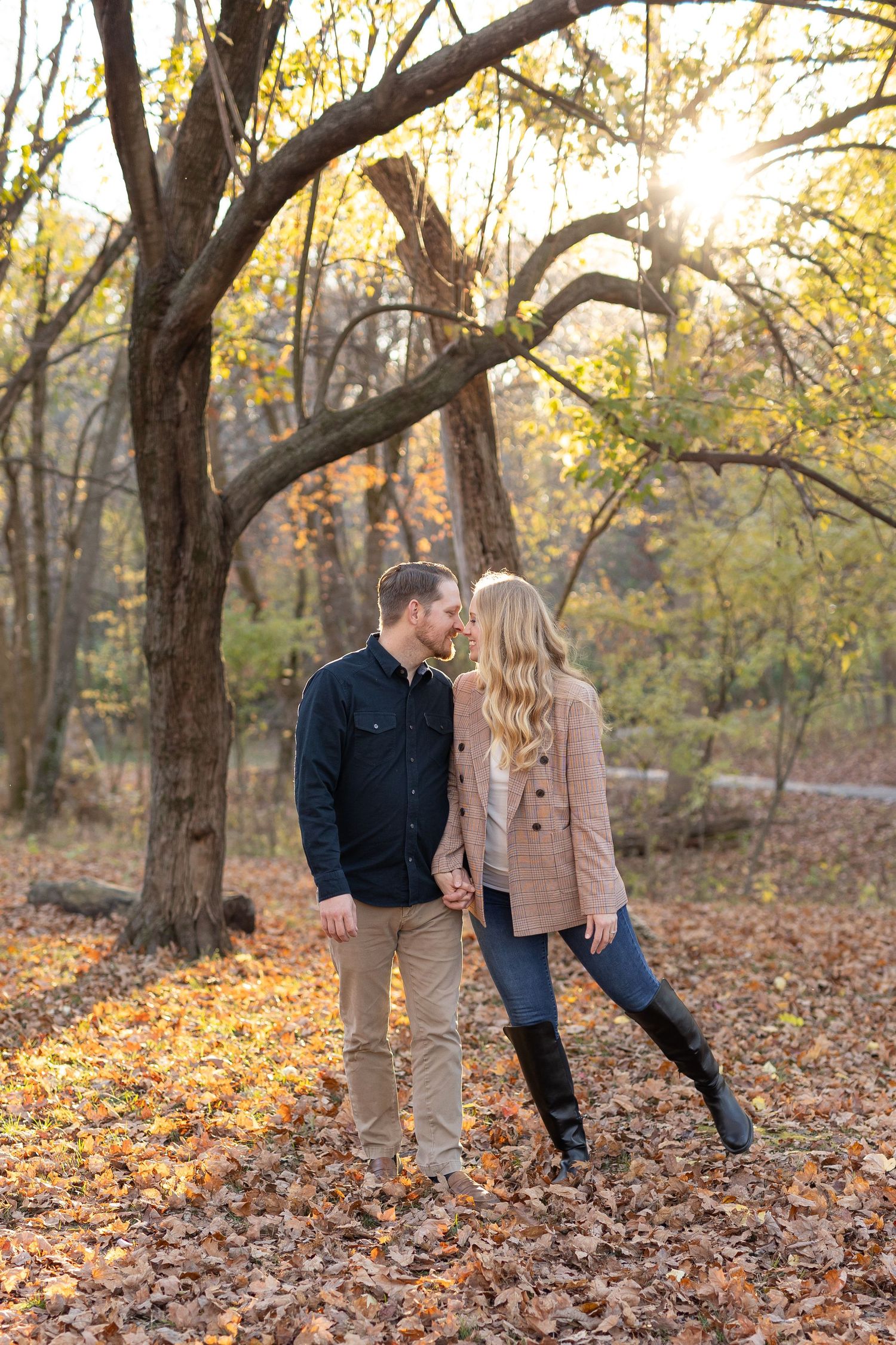 Couple smiling in a sunlit fall setting