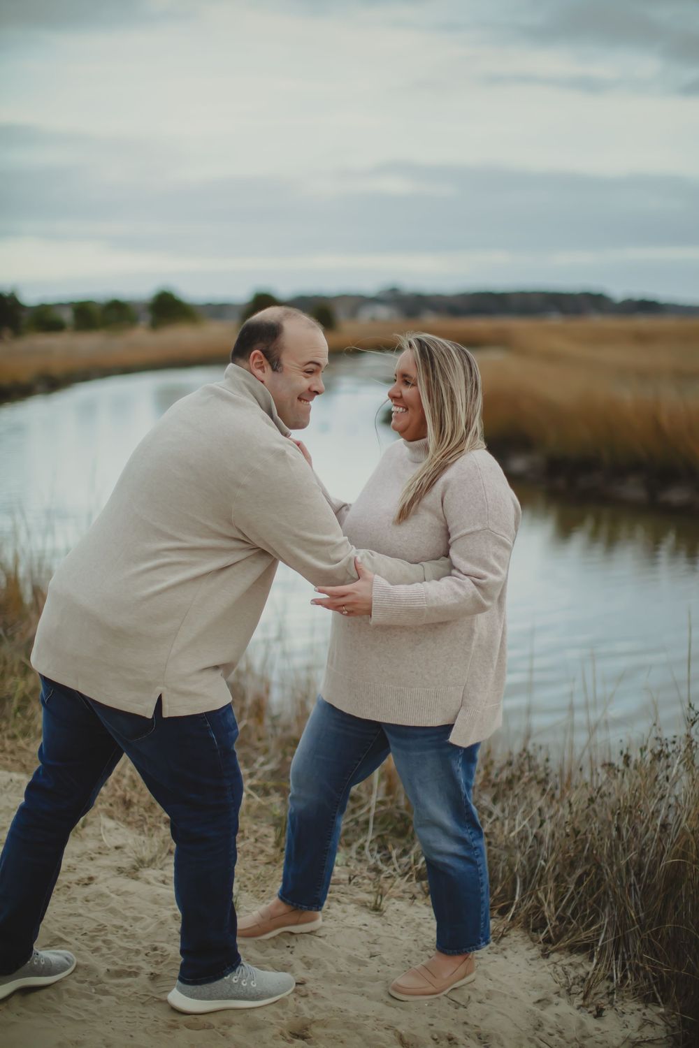 an man and his fiancé being cutesy