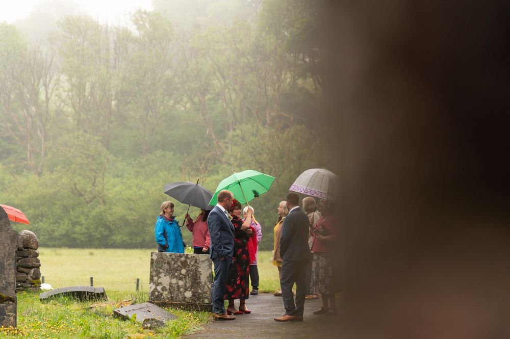 A misty outdoor gathering of people standing together in the distance.