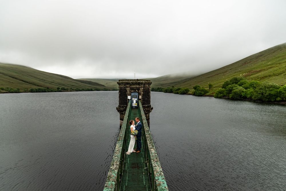 Scenic mountain lake landscape with moody clouds and misty atmosphere.