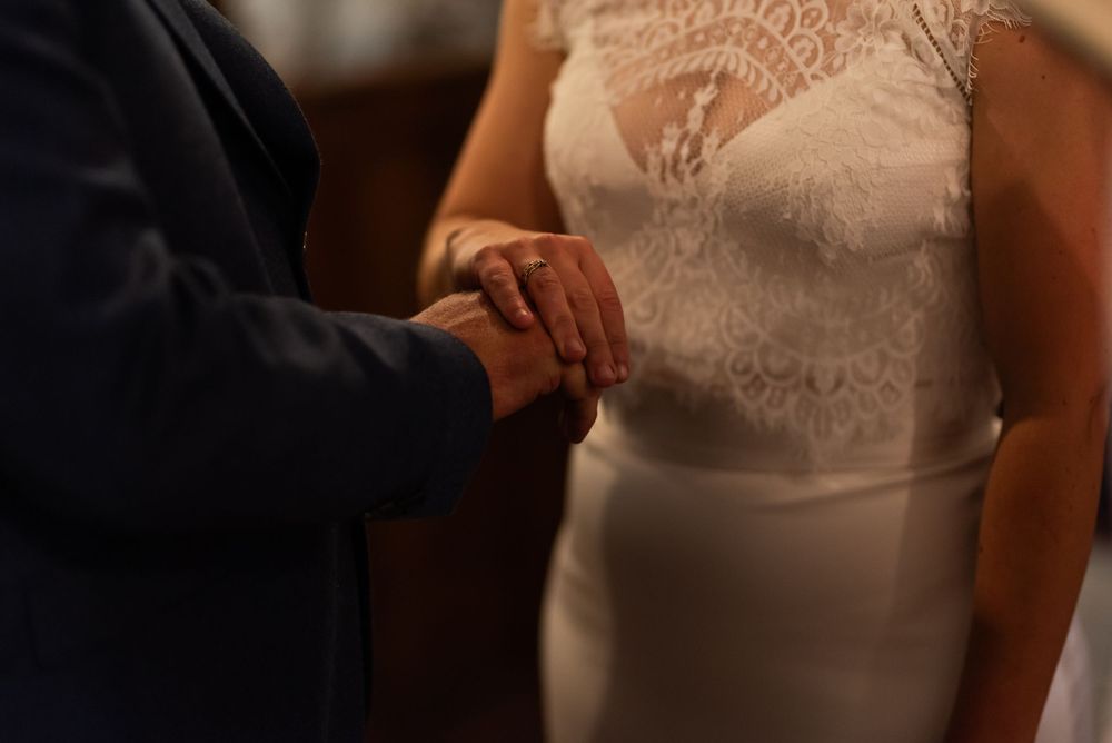 Close-up details of white lace wedding dress and formal attire.