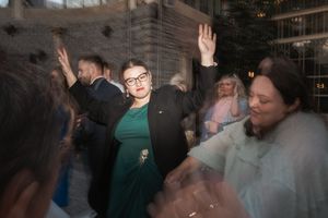 People celebrating and dancing at a lively indoor party with motion blur and atmospheric lighting.