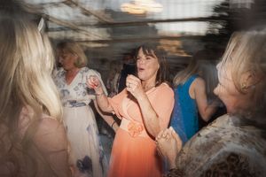 A group of seniors engage in lively conversation and activities at a social gathering event.