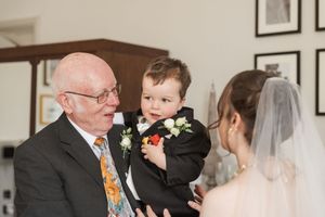 Elegant wedding reception with guests gathered in a formal indoor venue.