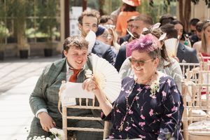Wedding guests in colorful attire enjoying an outdoor celebration.