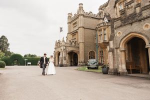 A historic stone building with Gothic architecture serves as a magnificent wedding venue.