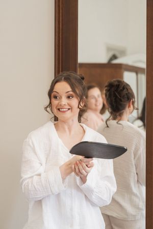 Bride getting ready for her wedding day shows joyful reactions in a series of candid moments.
