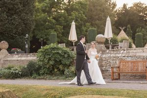 Scenic wedding venue with stone walls and garden setting during golden hour.