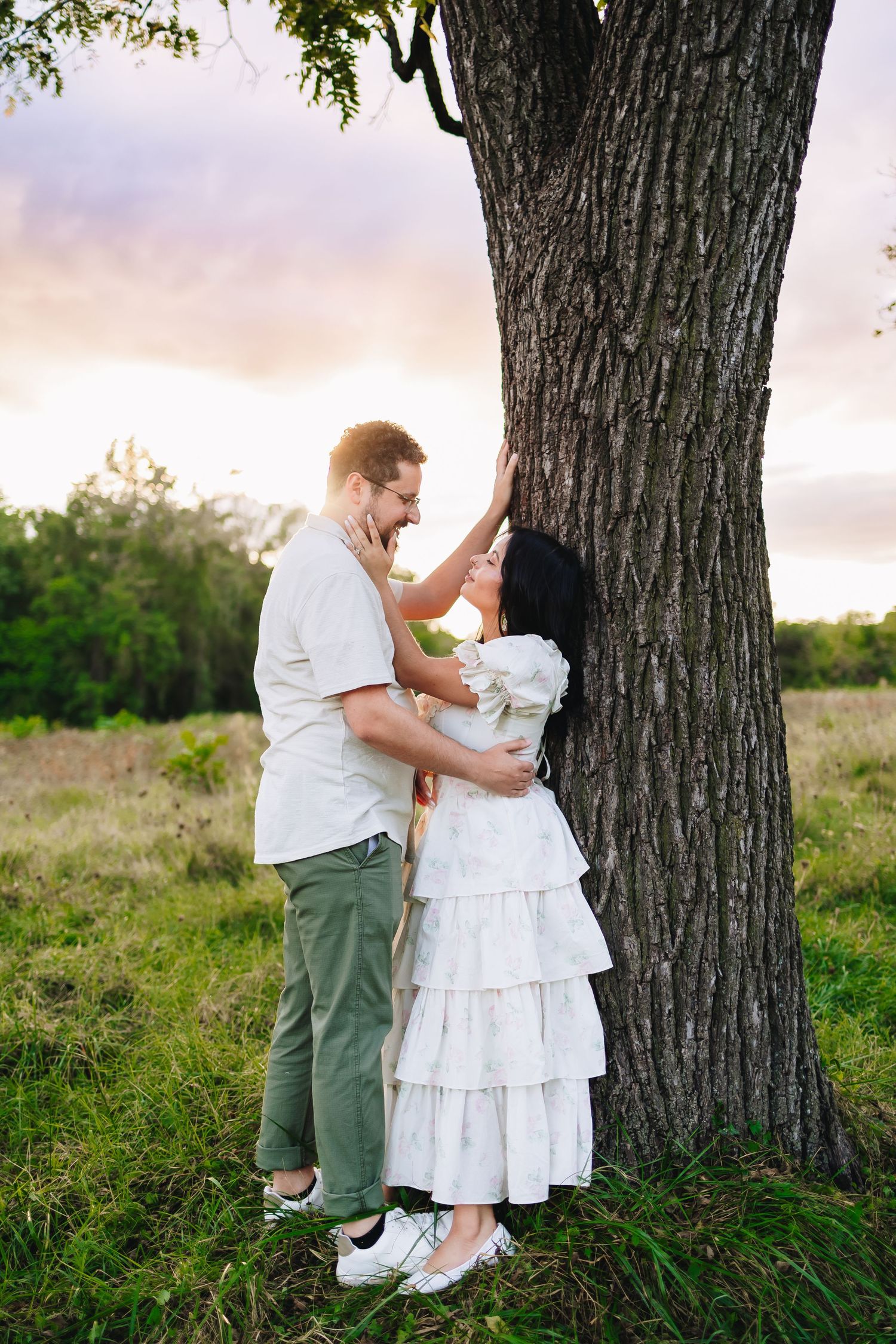 Series of engagement photos captured near a weathered wooden barn in a rural setting.
