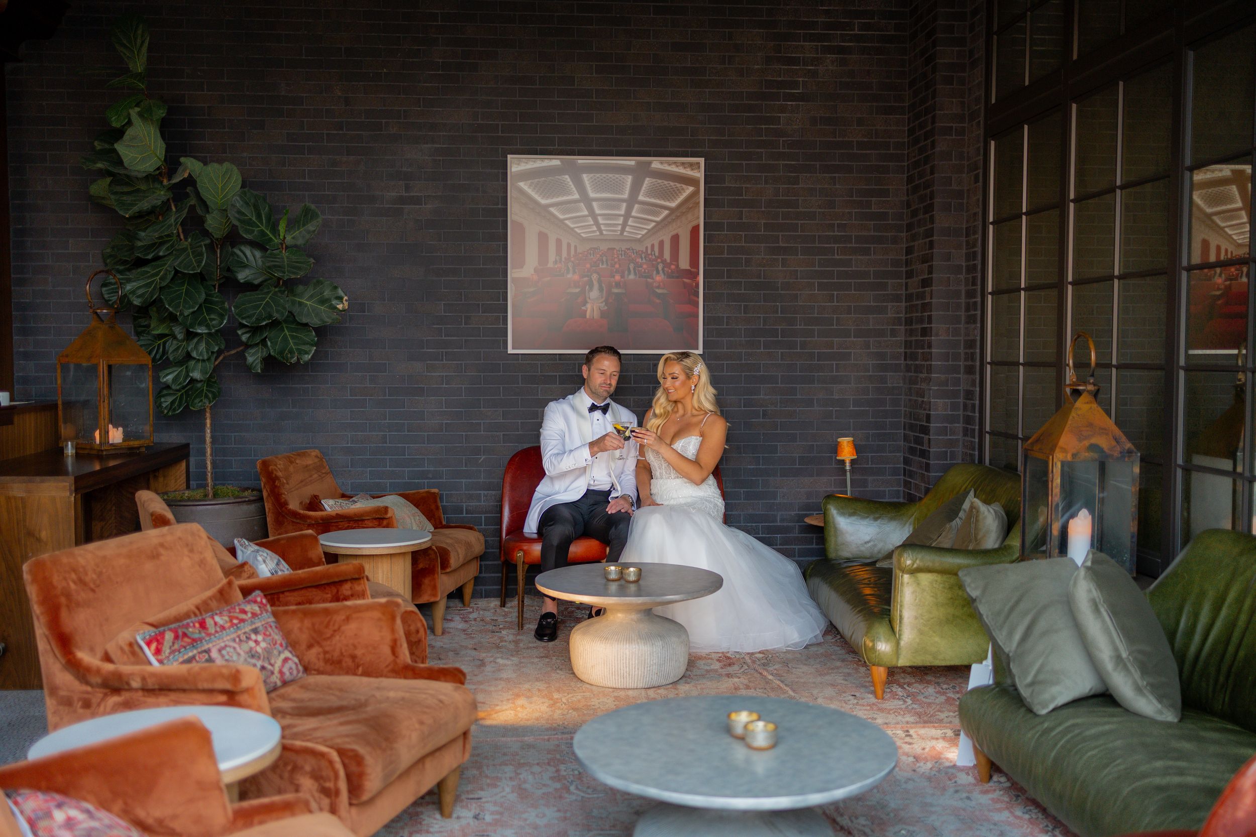 Bride and Groom having cocktail in moody room
