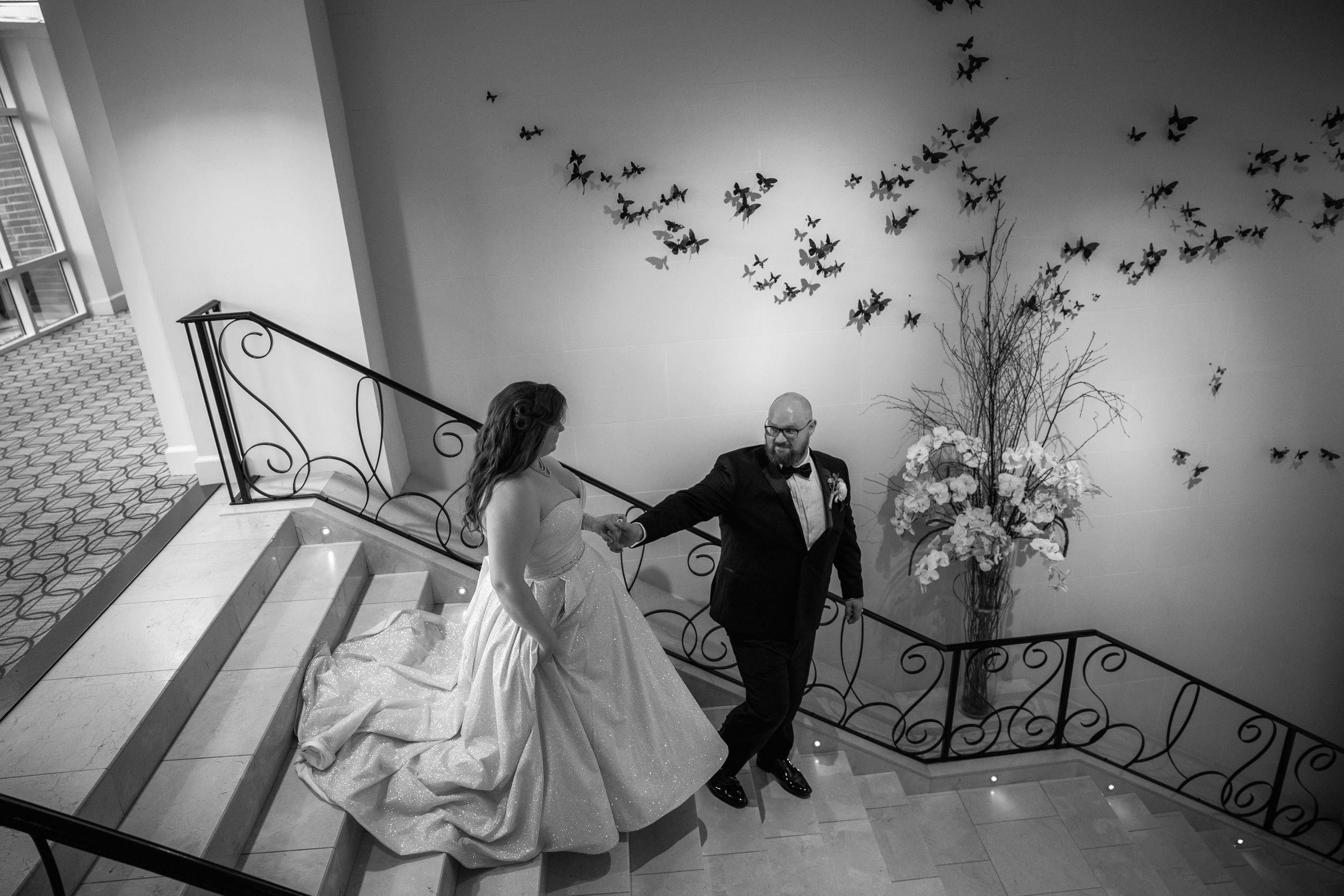 Bride and groom walking down stairs together