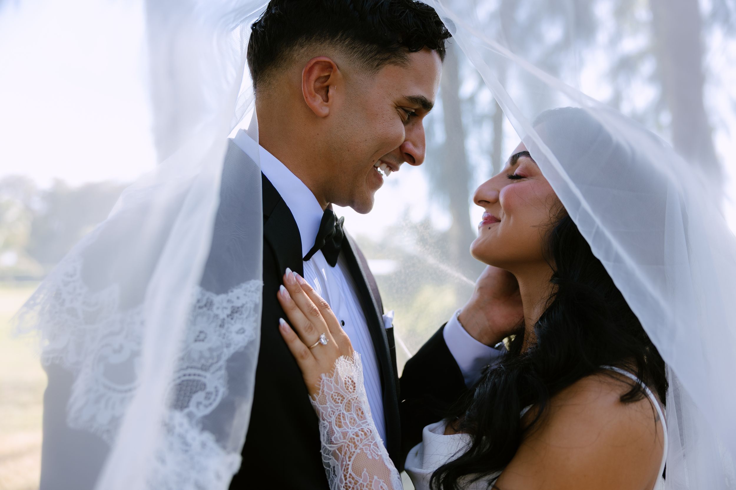bride and groom under veil at The Ranch 22 venue