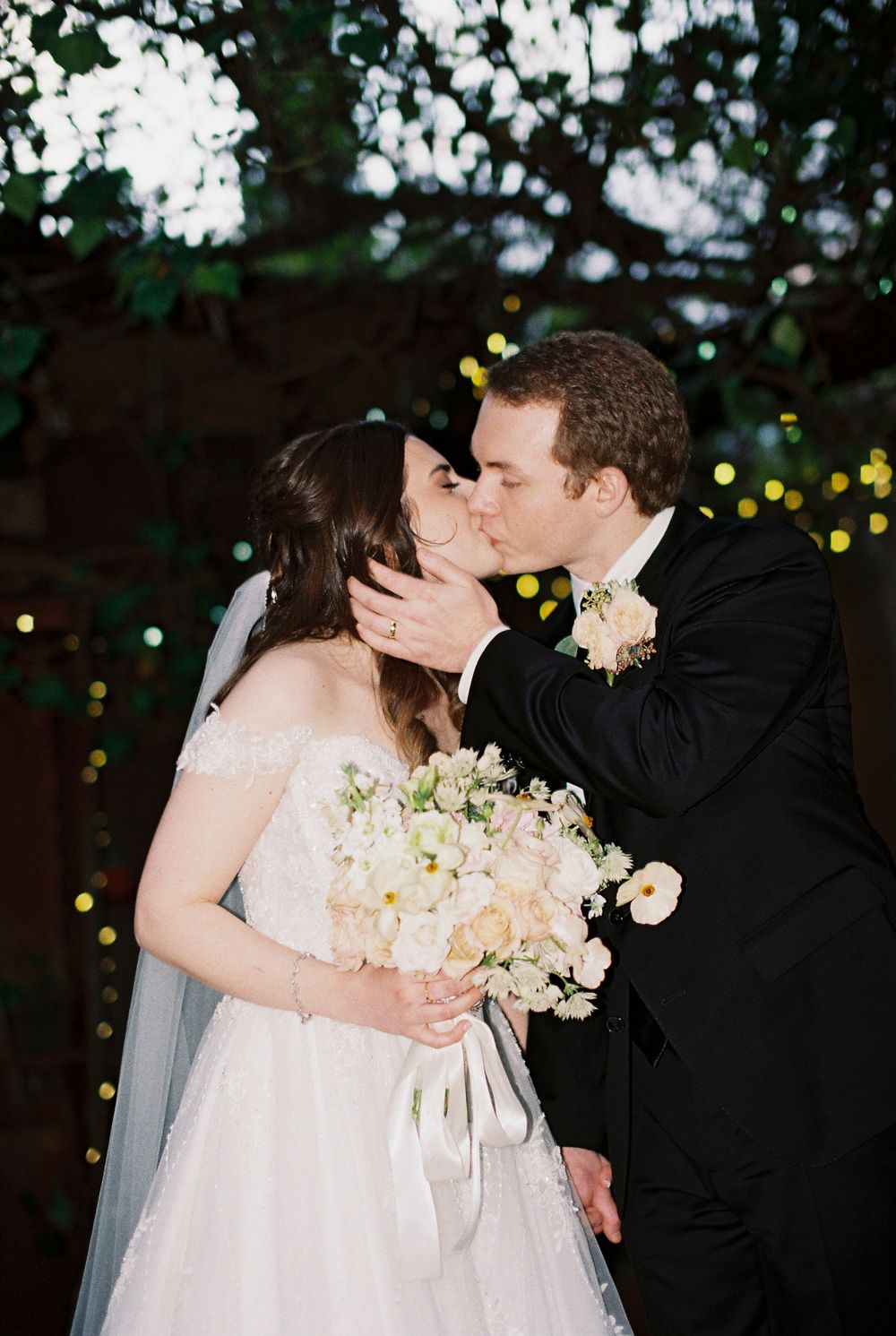 A direct flash photo of a couple kissing from an Asheville NC wedding photographer.