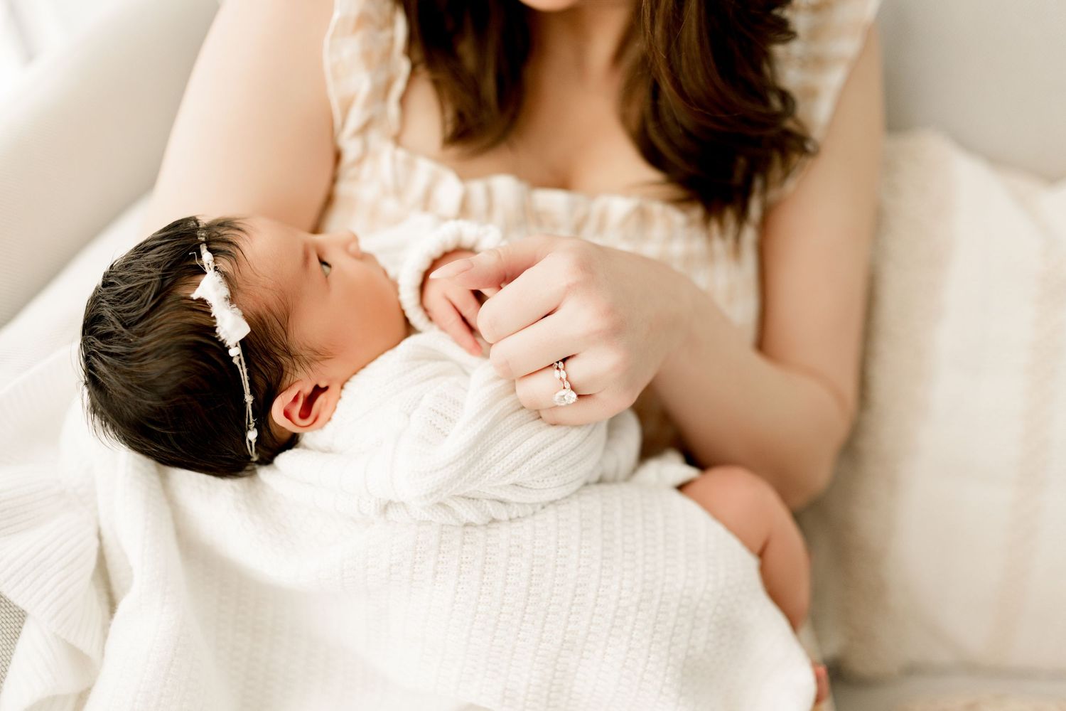 Mom holding a newborn baby girl during lifestyle photoshoot in Marion indiana