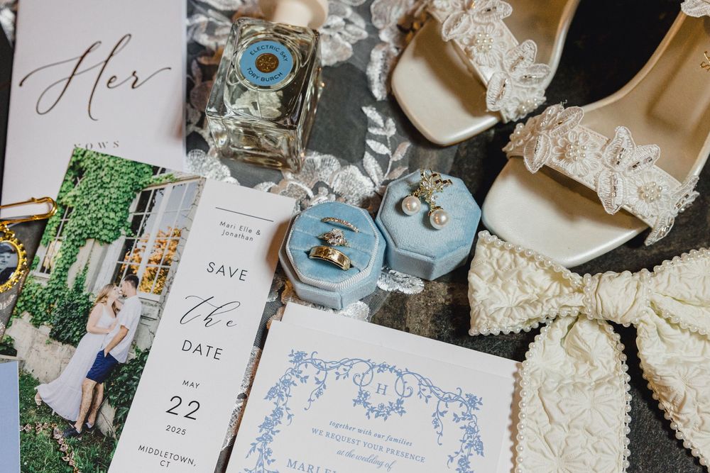 Wedding stationery and details featuring elegant blue designs and calligraphy on white paper.