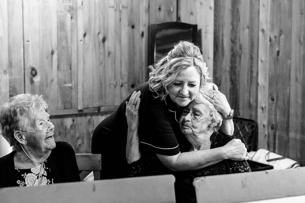 Black and white candid moments captured during an emotional gathering.
