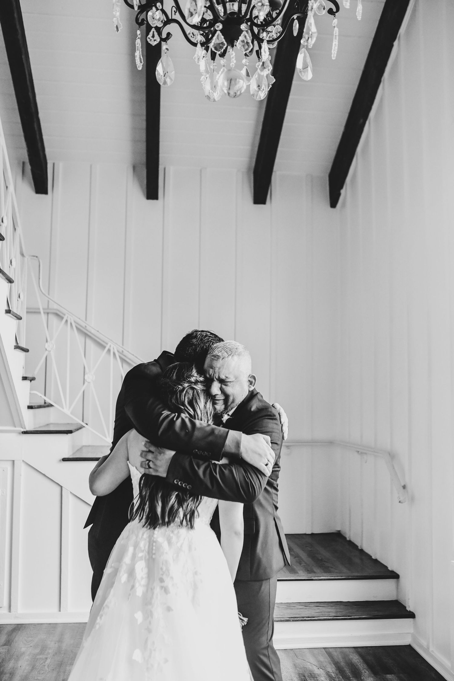 Father hugging bride during heartfelt wedding morning moment