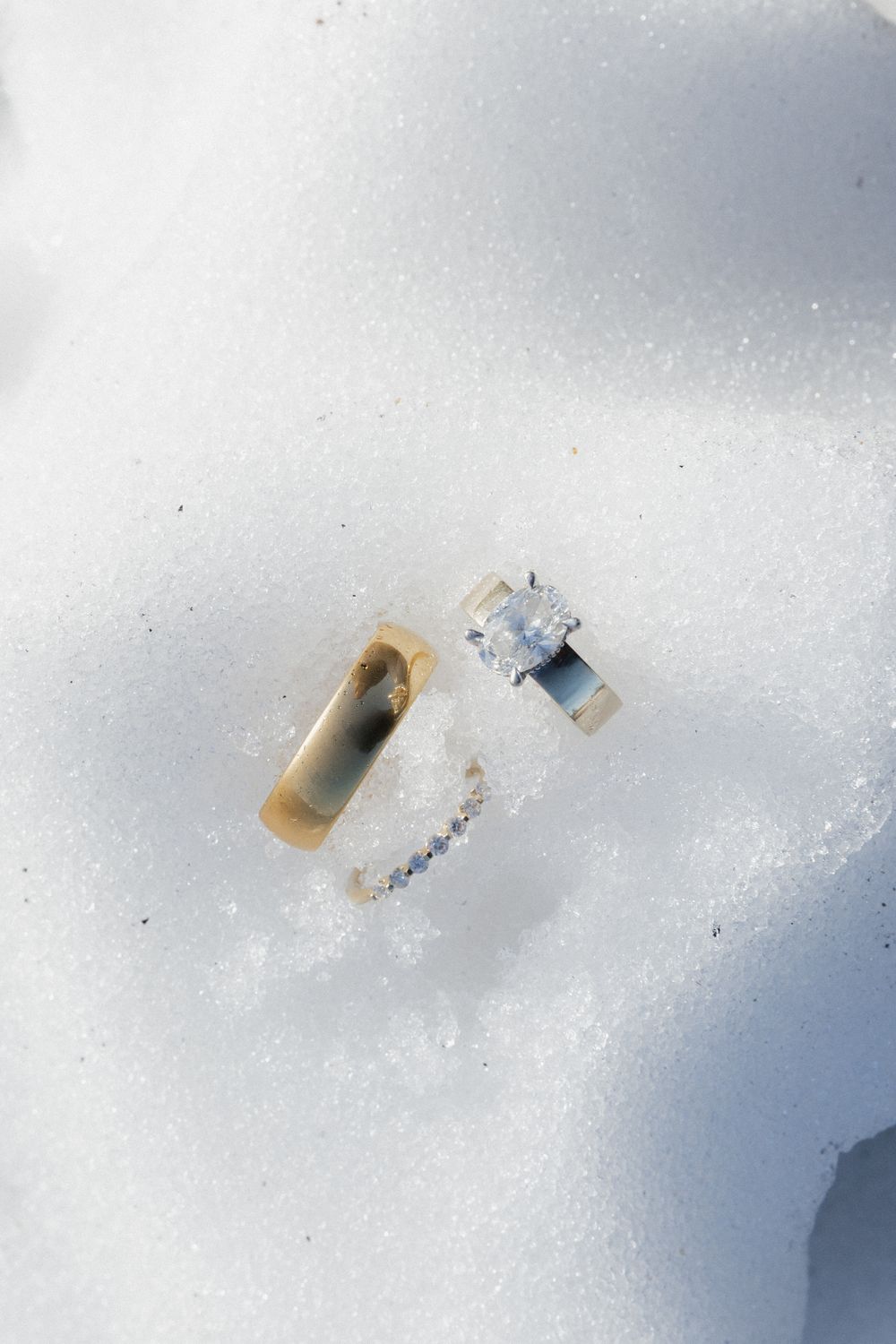 Scattered pieces of paper or documents lying on a white snowy surface.