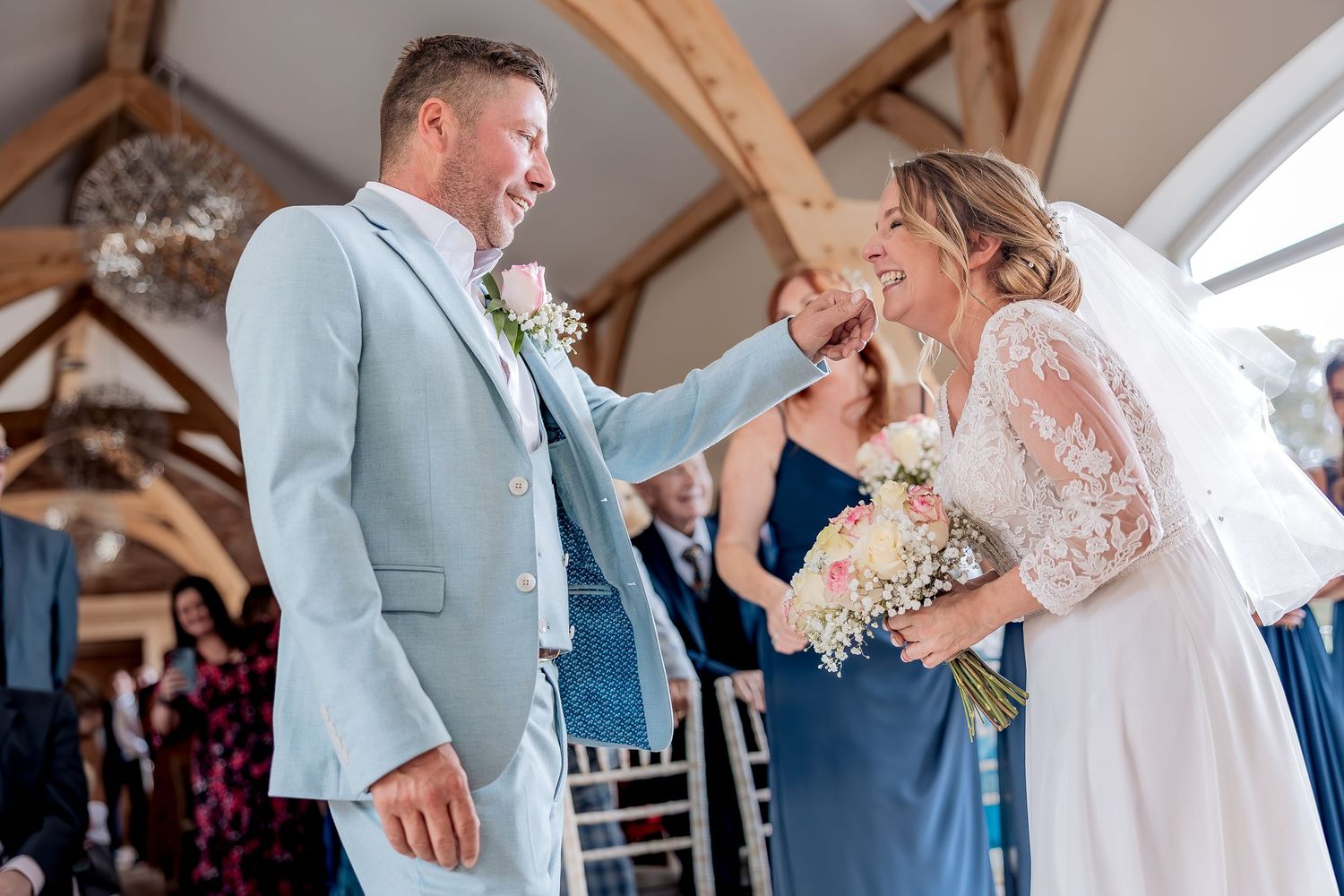 Couple laughing together during their wedding ceremony.