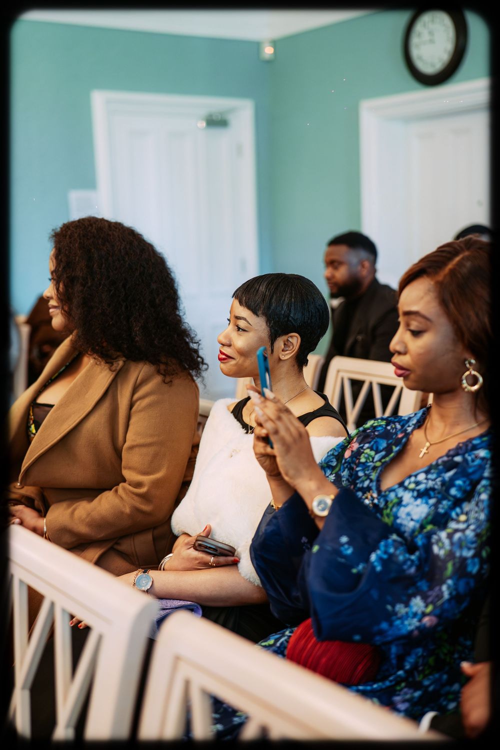 A group of people in blue attire sit together in a church pew during a service.