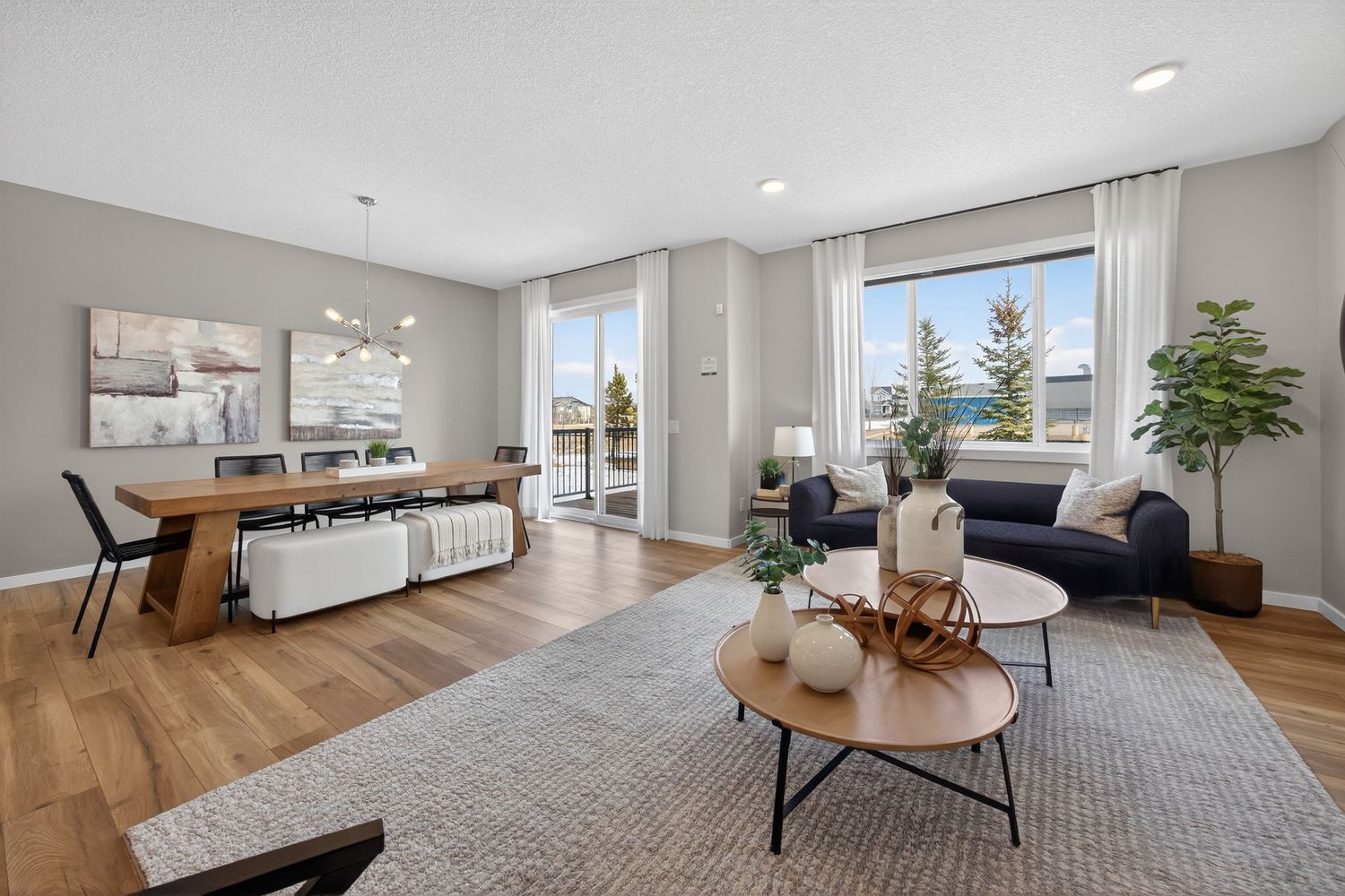 Modern white kitchen interior with pendant lights and sleek cabinetry showcasing contemporary design.