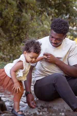 Outdoor Family Session daddy and daughter sitting in the rocks