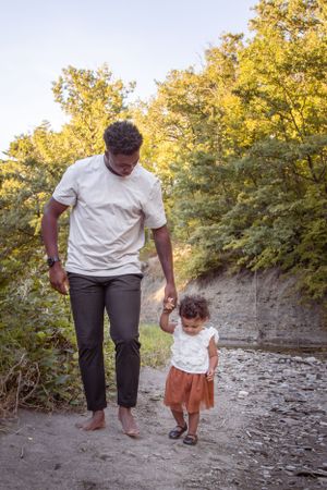 Outdoor Family Session Daddy & daughter holding hands walking on shoreline