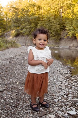 Outdoor Family Session toddler on rocky shoreline smiling