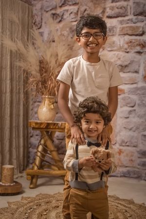 Family session with boho setup sibling shot