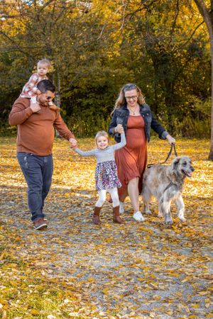 Fall Family session parents walking with kids and dog
