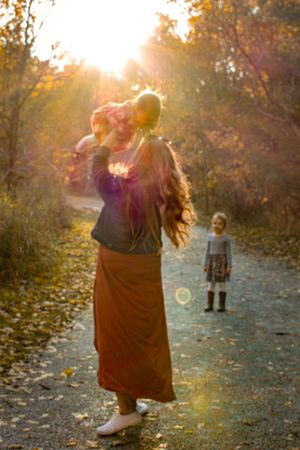 Fall Family session mommy throwing baby in the air during sunset