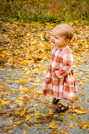 Mississauga Outdoor Fall Family photos toddler walking in leaves