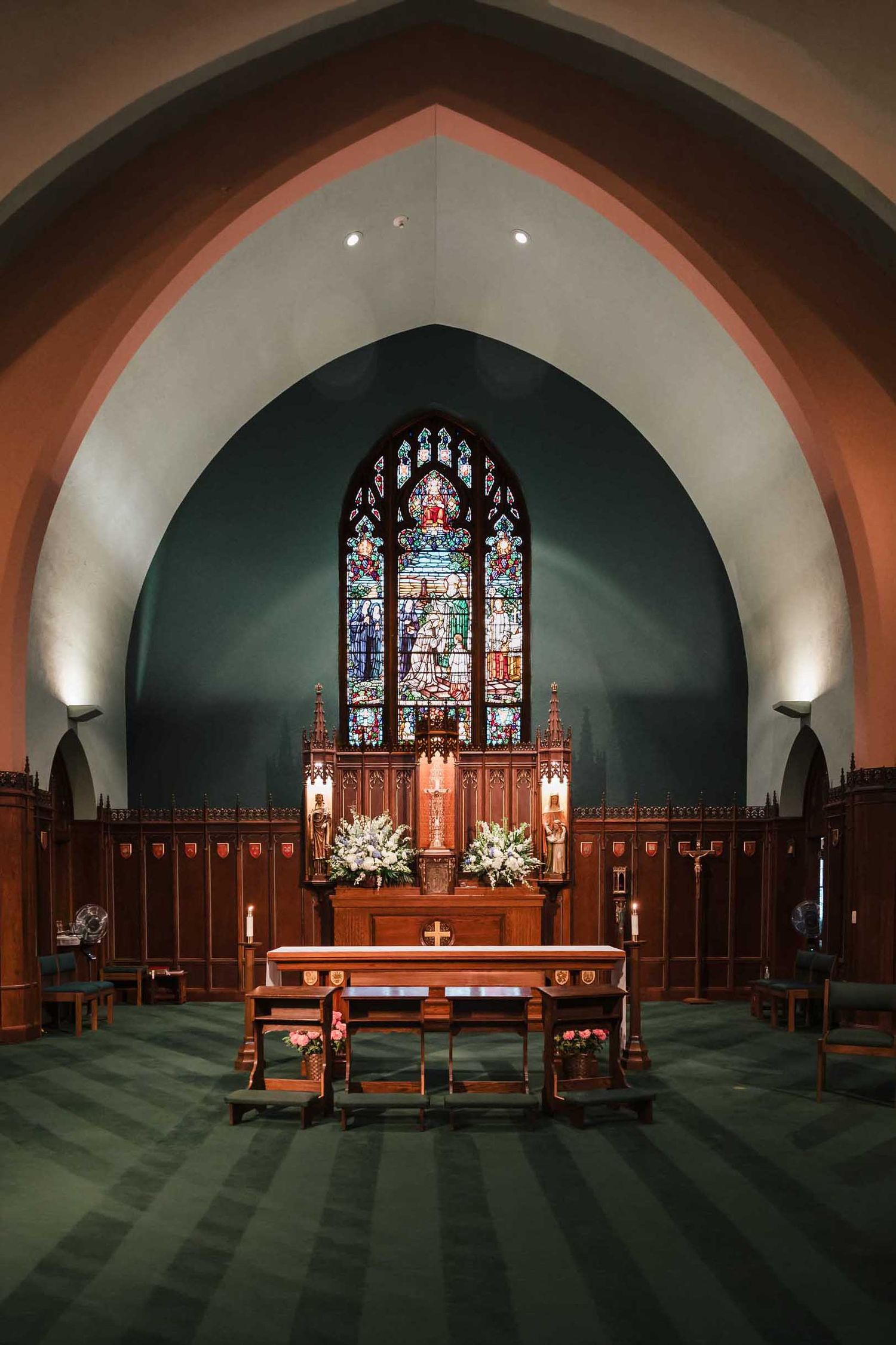 Altar and stained glass inside Saint Brigid Church in South Boston set up for a wedding ceremony