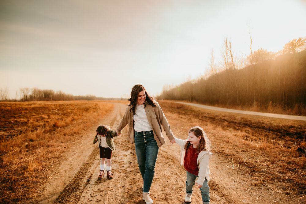 Walking together on a rustic dirt path during golden hour sunset.