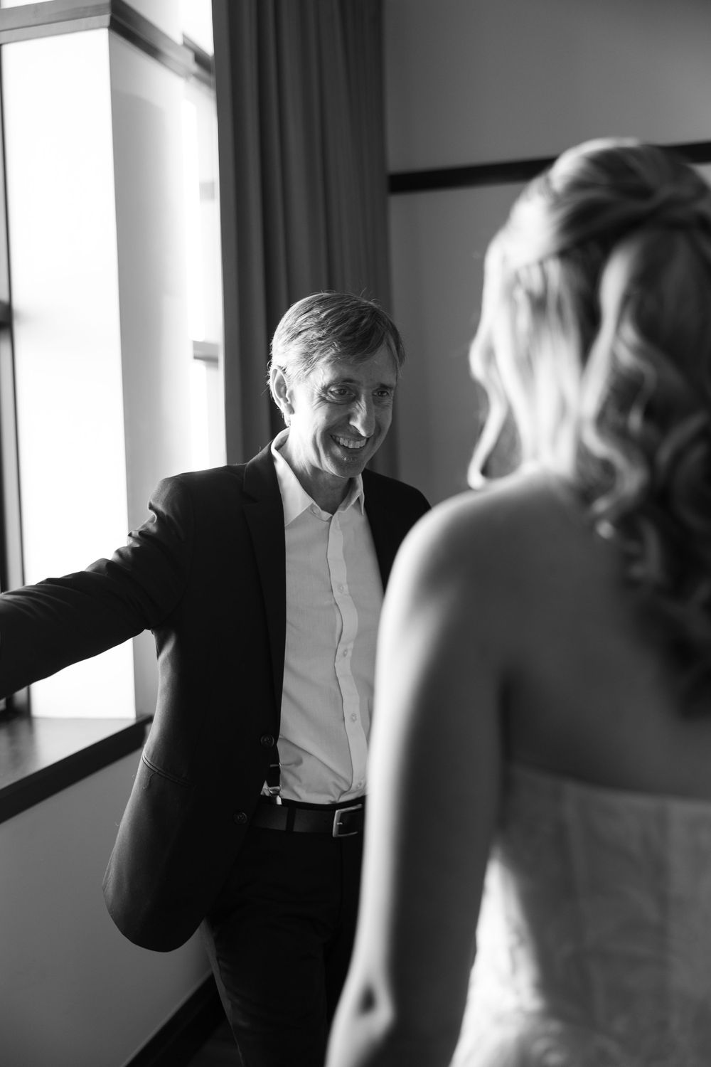 Series of candid black and white photos showing joyful interactions at a formal event.