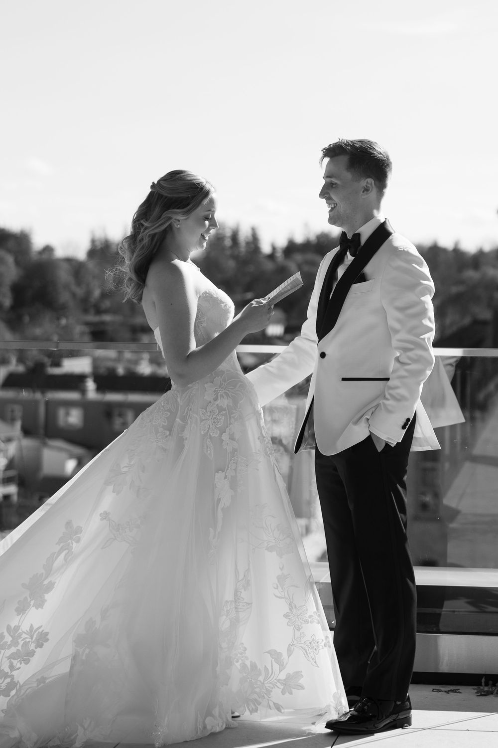 A romantic wedding photo sequence showing a couple embracing on a rooftop terrace in black and white.