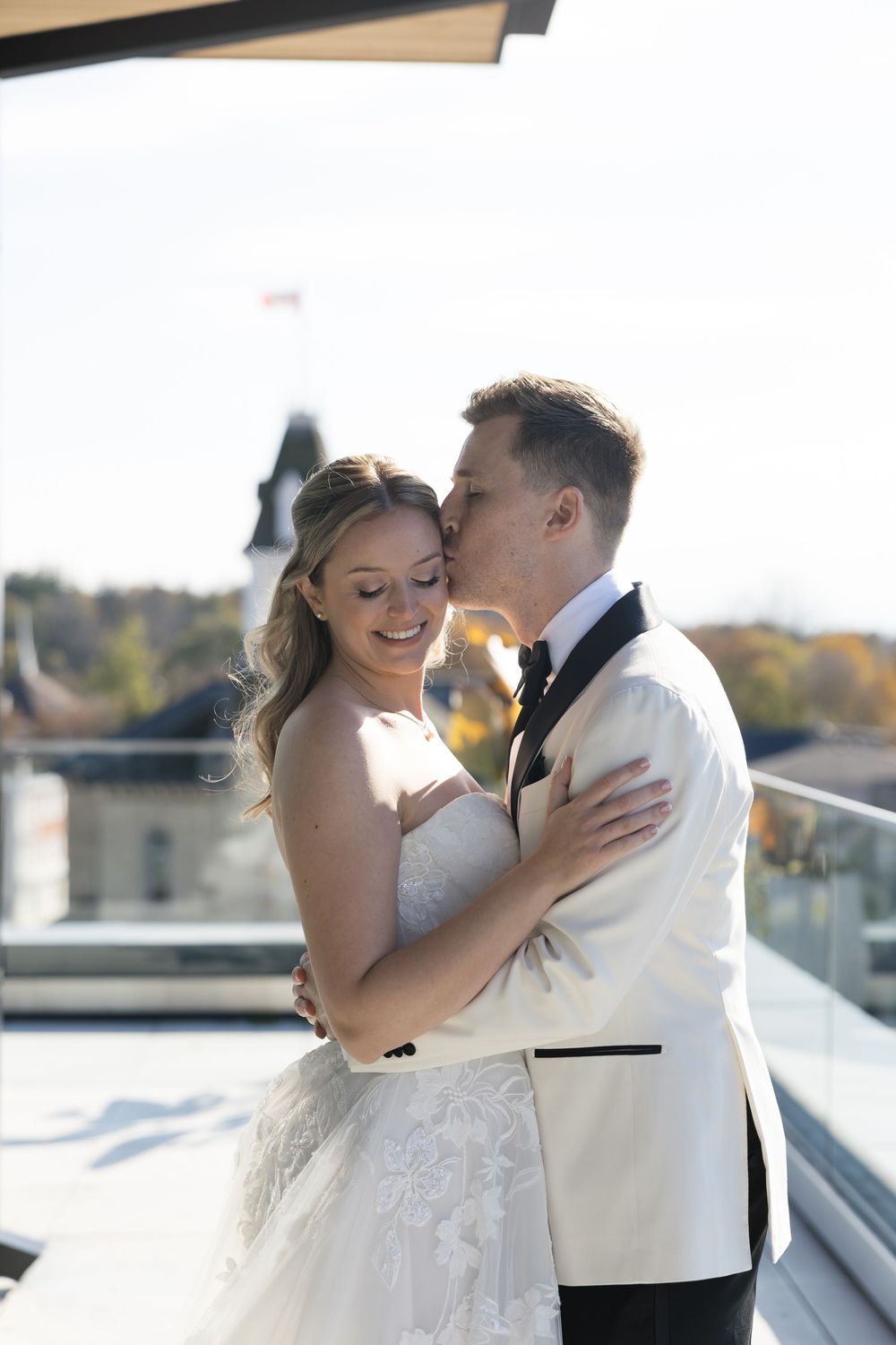 Newlyweds share intimate moments during their outdoor wedding photoshoot in warm sunlight.