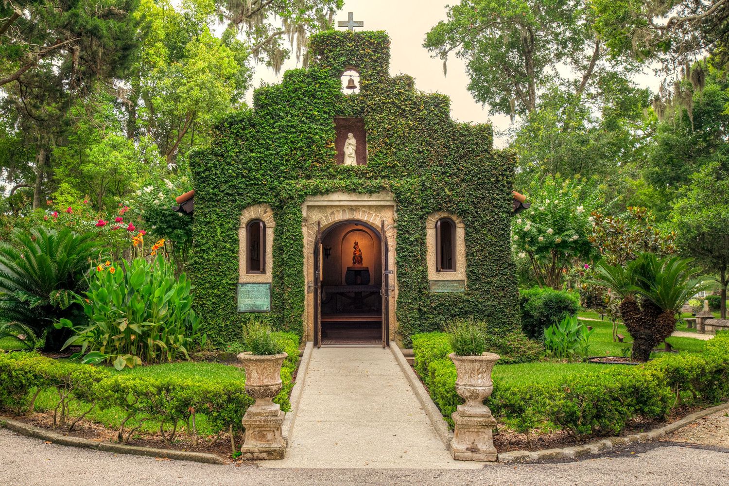 Ivy-covered Chapel of Our Lady of La Leche surrounded by lush gardens in St. Augustine, Florida.